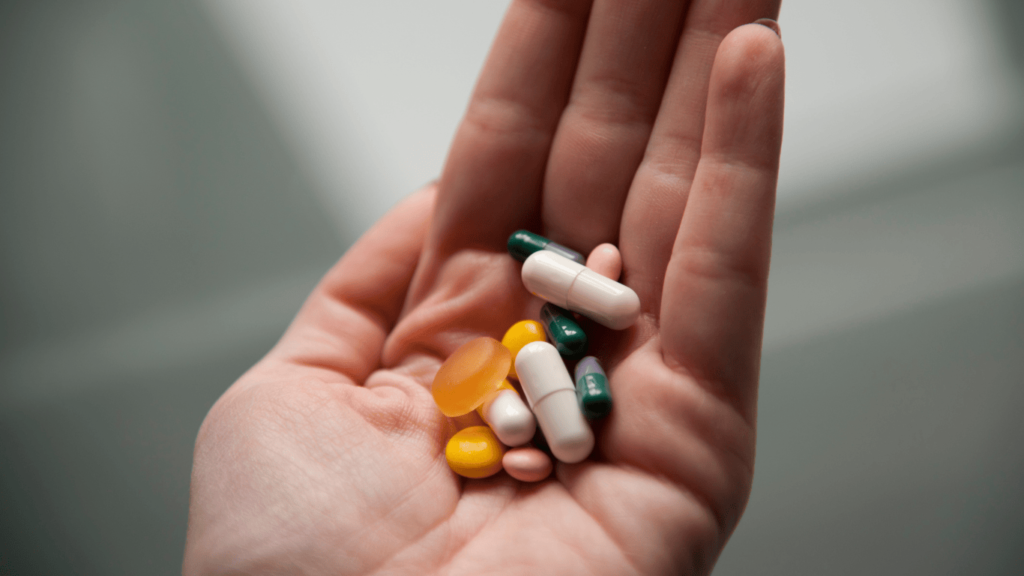 Pastillas apoyadas en una mano que esta en primer plano